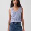 Blusa corta con peplum y lazo frontal con ojales