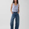 Blusa corta con peplum y lazo frontal con ojales