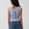 Blusa corta con peplum y lazo frontal con ojales