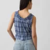 Blusa corta con peplum y lazo frontal con ojales