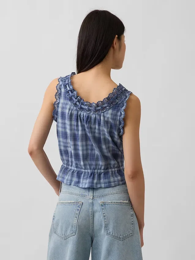 Blusa corta con peplum y lazo frontal con ojales