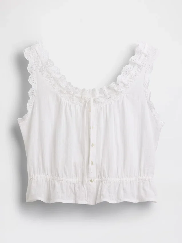 Blusa corta con peplum y lazo frontal con ojales