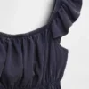 Blusa infantil con peplum, mangas con volantes y fruncido