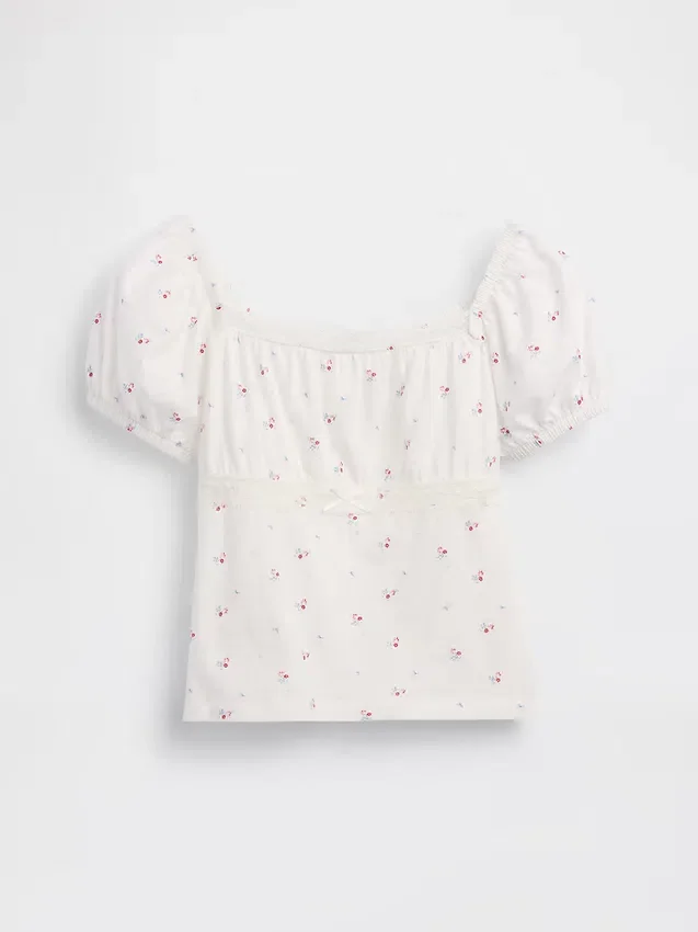 Blusa infantil de mangas abullonadas con ribete de encaje
