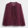 Blusa transparente con inserciones de encaje reciclado y cuello con lazo