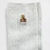 Calcetines de cuello alto con tejido trenzado y el oso Brannan