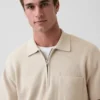 Jerséu polo oversize con bolsillo y cremallera de un cuarto